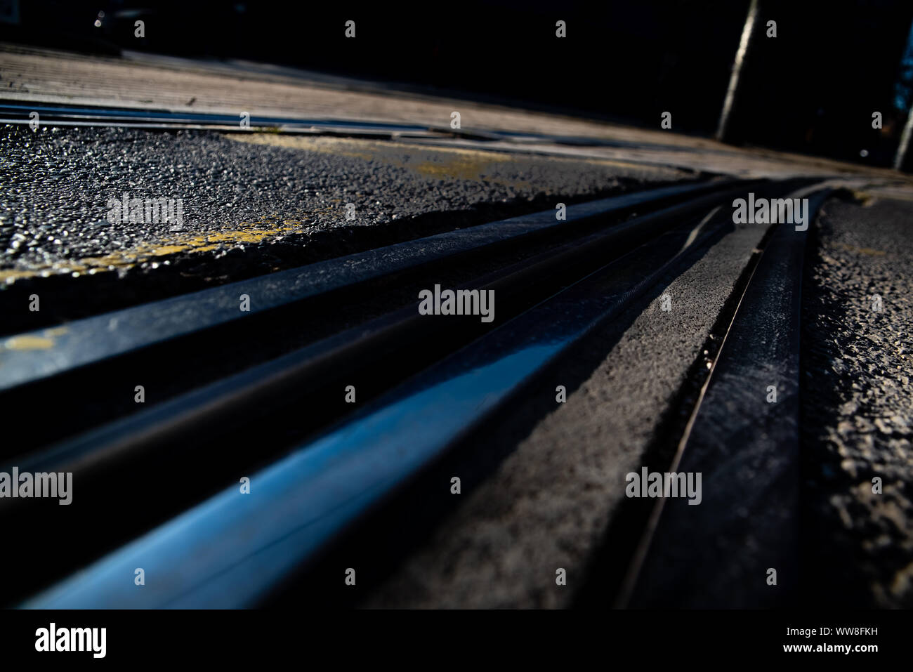 Tracks of an urban tram between the asphalt of a street Stock Photo - Alamy