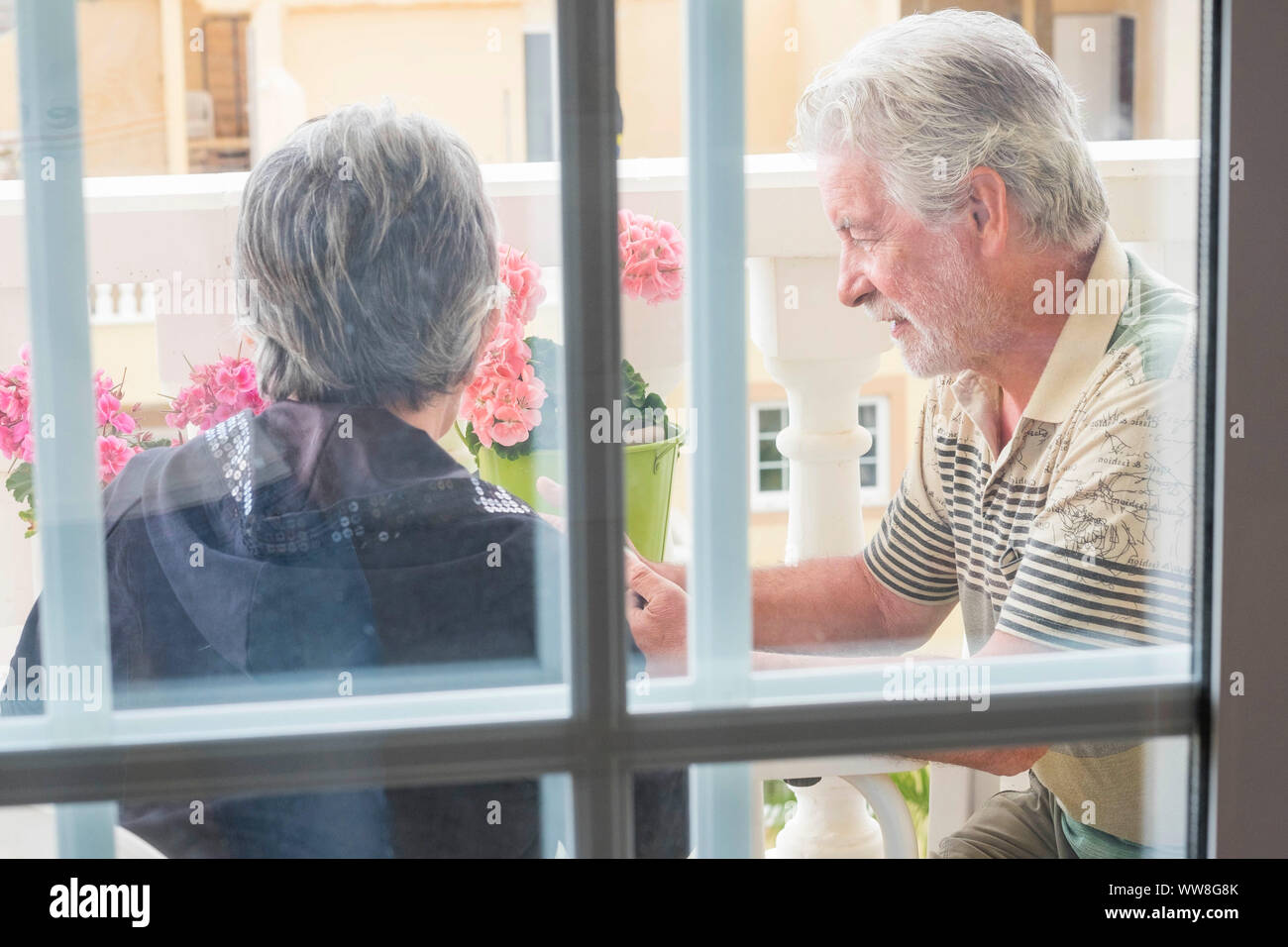 outdoor couple of adult aged senior on the terrace at home, foreverness life Stock Photo