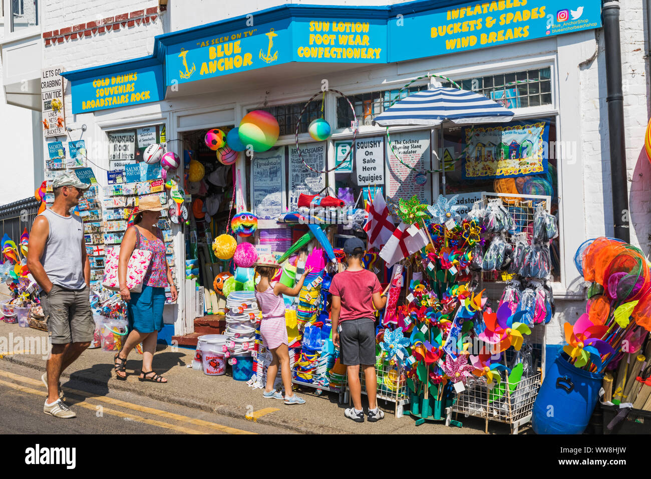 England, Kent, Thanet, Broadstairs, Family Looking at Shop Display of Beach Goods Stock Photo
