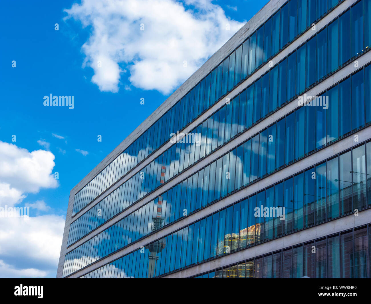 Cloudy sky reflected in the glass wall of a high building Stock Photo ...