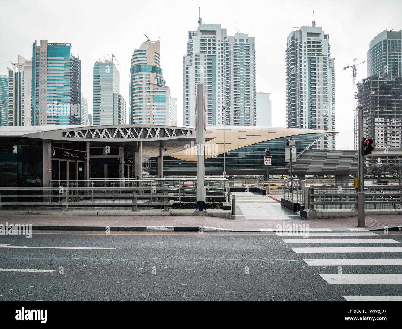 Futuristic building of Dubai metro station and modern skyscrapers in Dubai, United Arab Emirates Stock Photo