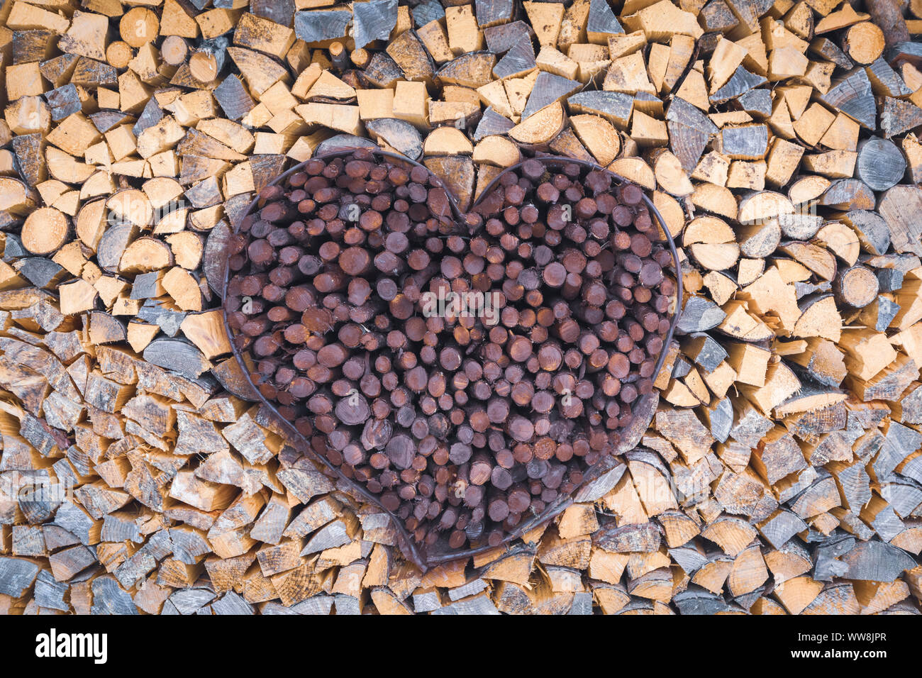 firewood stacked in the shape of a heart Stock Photo