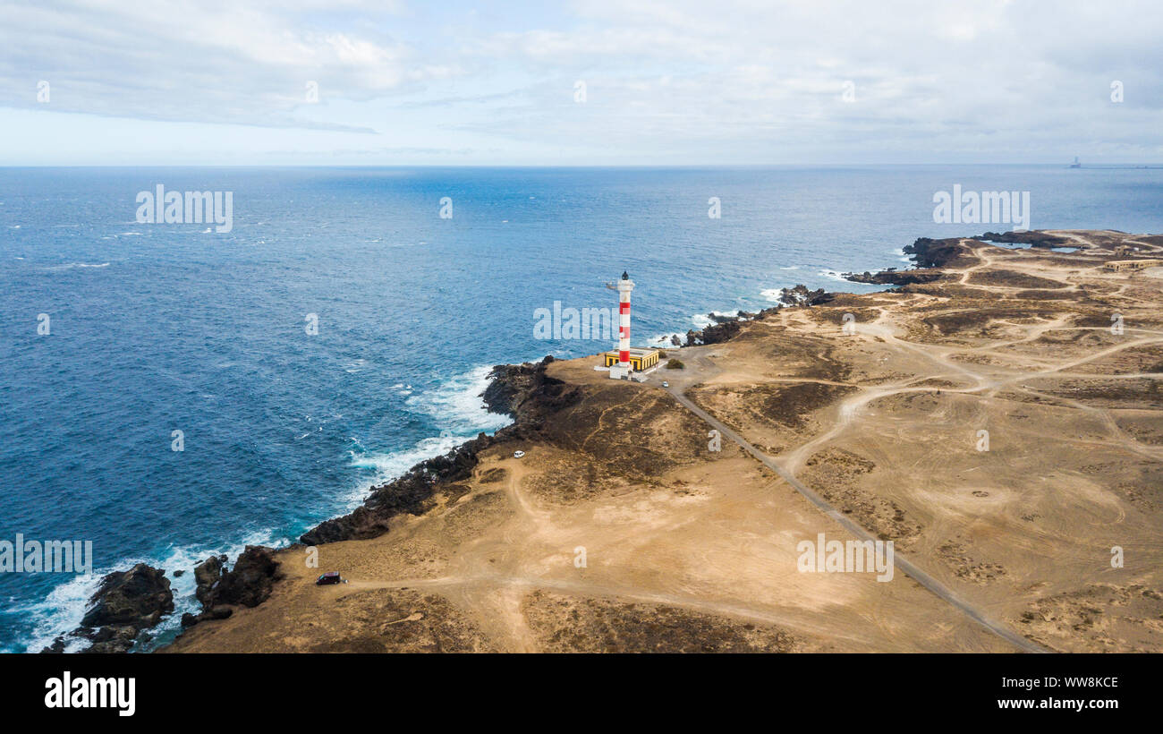 aerial point of view of lighthouse on the coast to make light on the ocean for ships. many roads to go everywhere and discover places in the desert. travel adventure concept Stock Photo