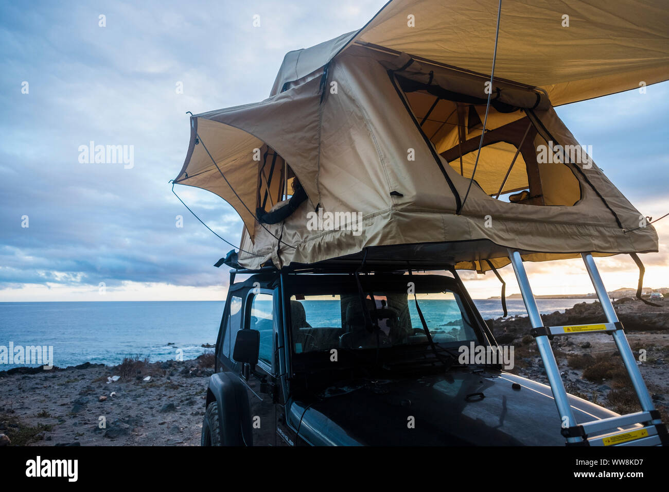 black off road beautiful adventurer car vehicle with roof tent tiny house perfect to travel and live amazing journey around the world. home where you park. ocean view Stock Photo