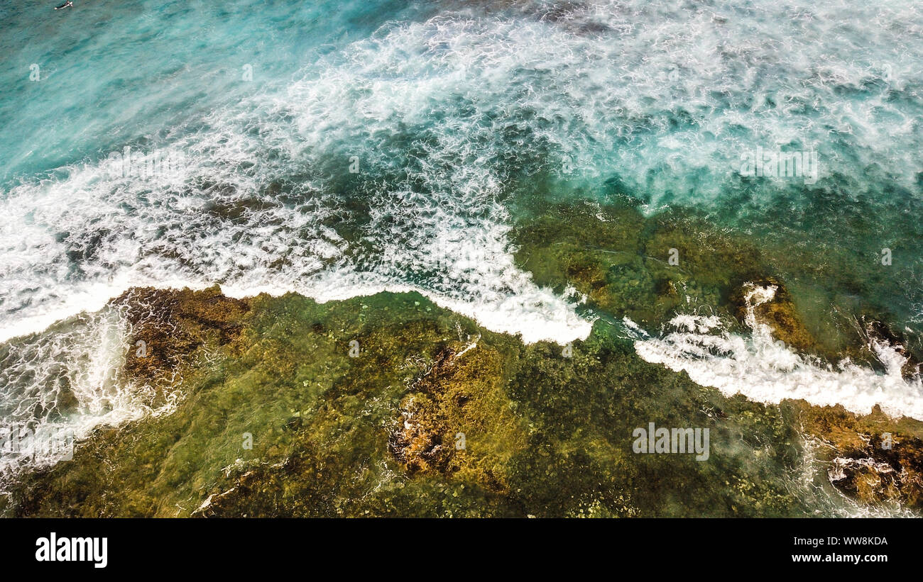 ocean's coast aerial view with blue waves and green natural rocks, vacation and adventure journey concept outdoor Stock Photo