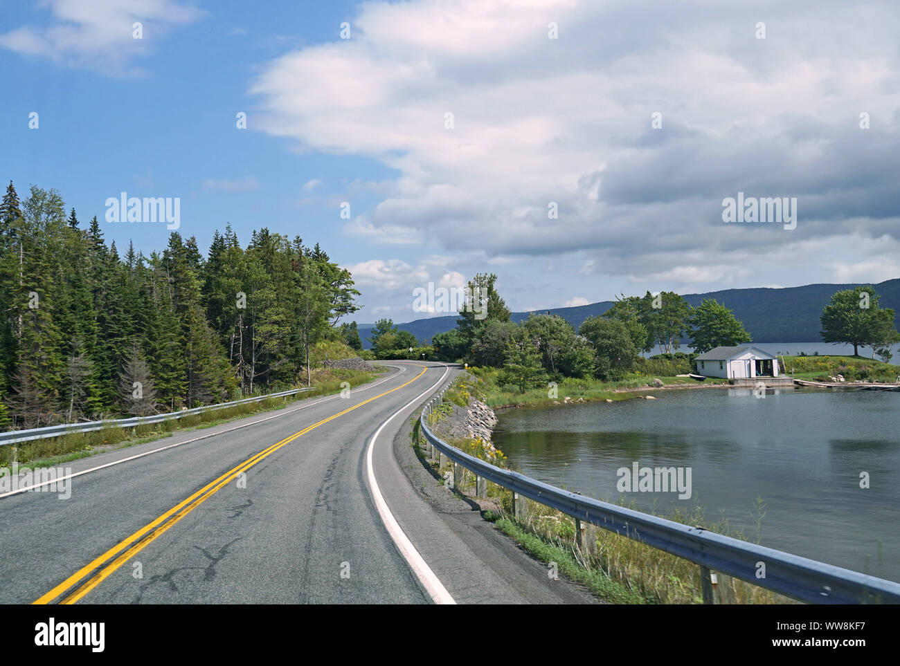 Curving lakeside road, Cabot Trail, Nova Scotia, beside Bras d'Or Lake Stock Photo