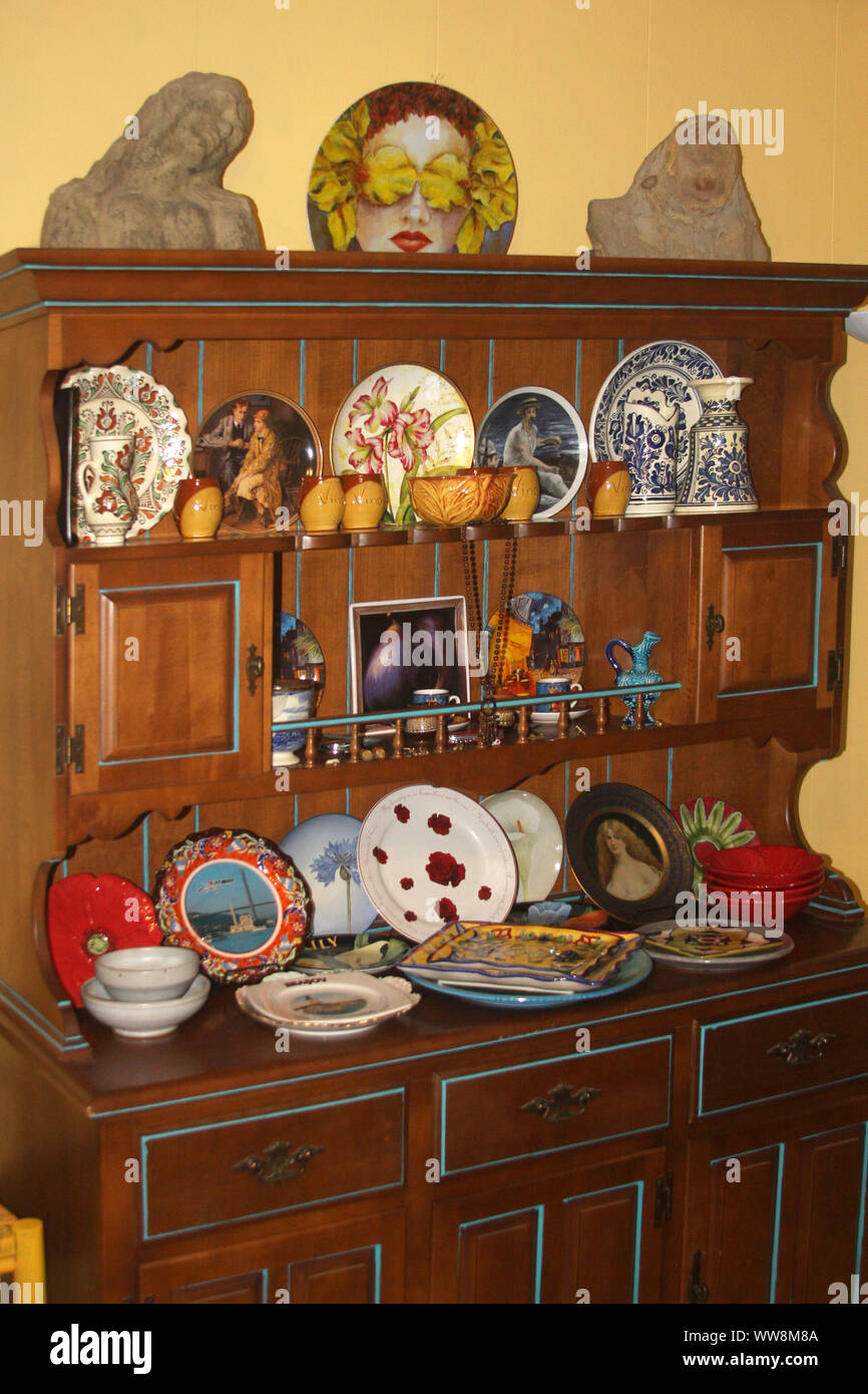 Decorative plates in a cupboard Stock Photo Alamy
