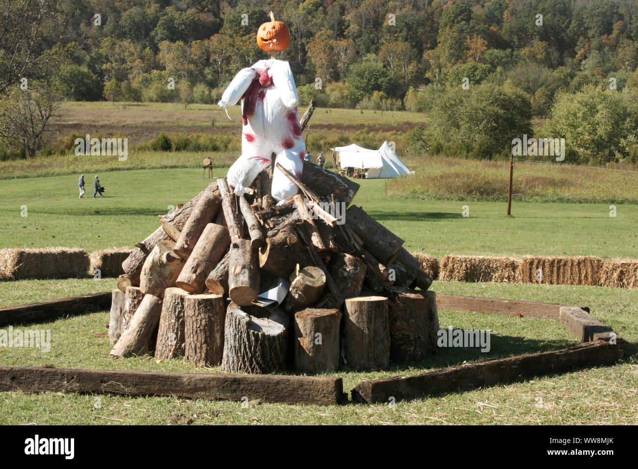 A pumpkin head- scarecrow ready to be burned on large campfire at Halloween festival at James River State Park in Virginia, USA Stock Photo