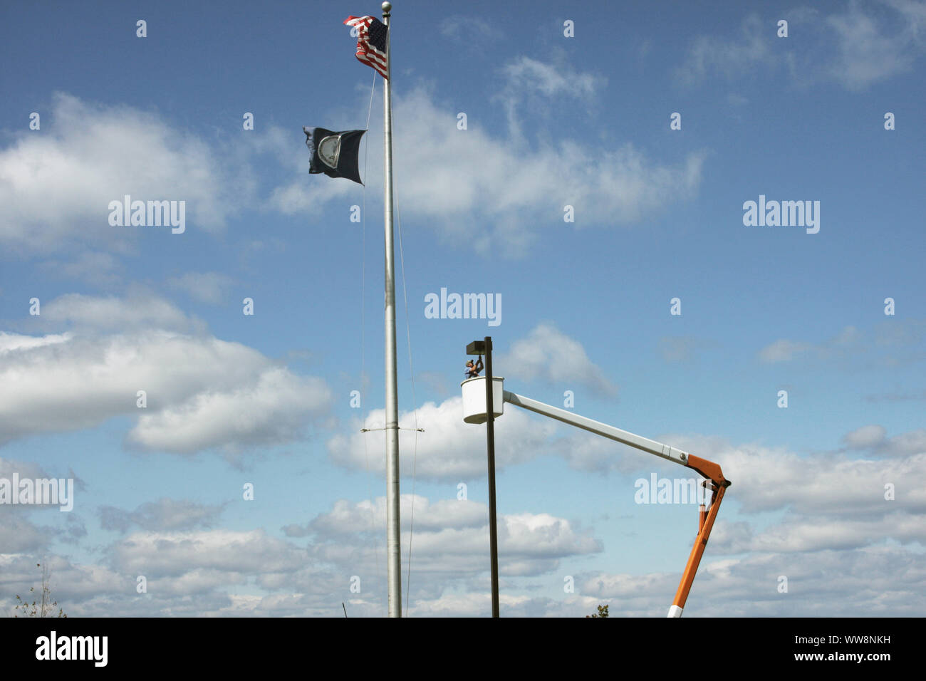 Electrician working on a street light using a bucket truck. U.S.A Stock