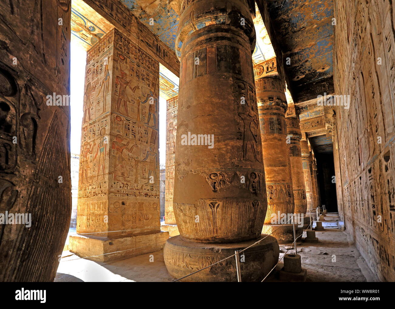 Column hall with reliefs and original colours in the second courtyard in the death temple of Ramses III Medinet Habu in Thebes-West, Luxor, Upper Egypt, Egypt Stock Photo