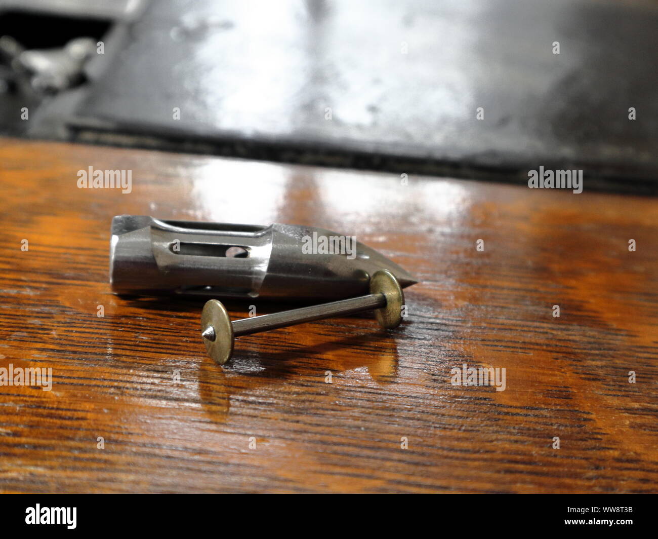 Close up of bobbin and shuttle from an antique sewing machine in working order Stock Photo