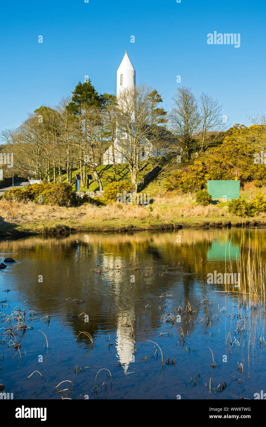 The round tower of Kilmore Church reflected in Loch na Cuilce at Dervaig, Isle of Mull, Scotland, UK Stock Photo