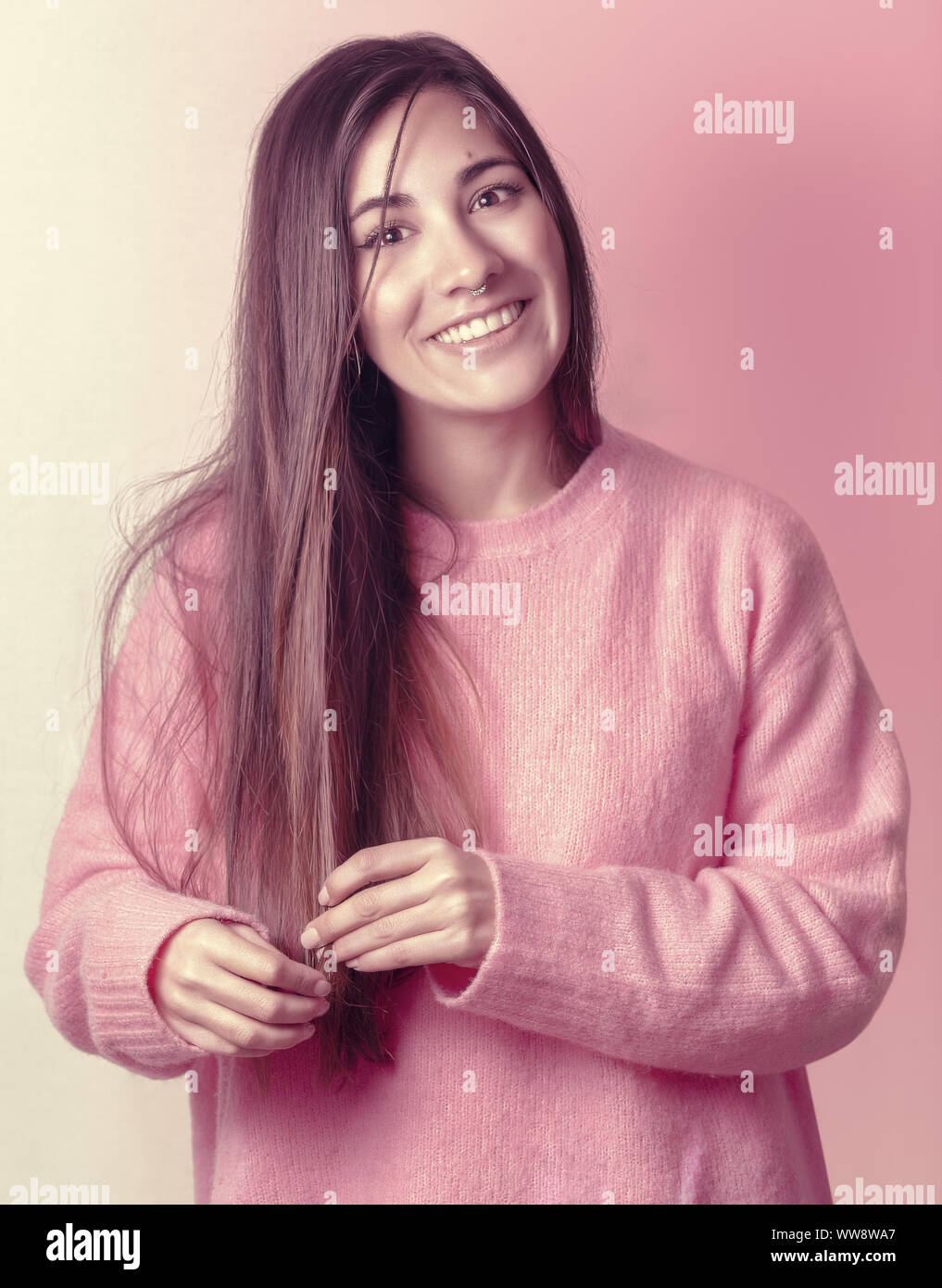 Pretty girl with straight hair and a pink sweater Stock Photo