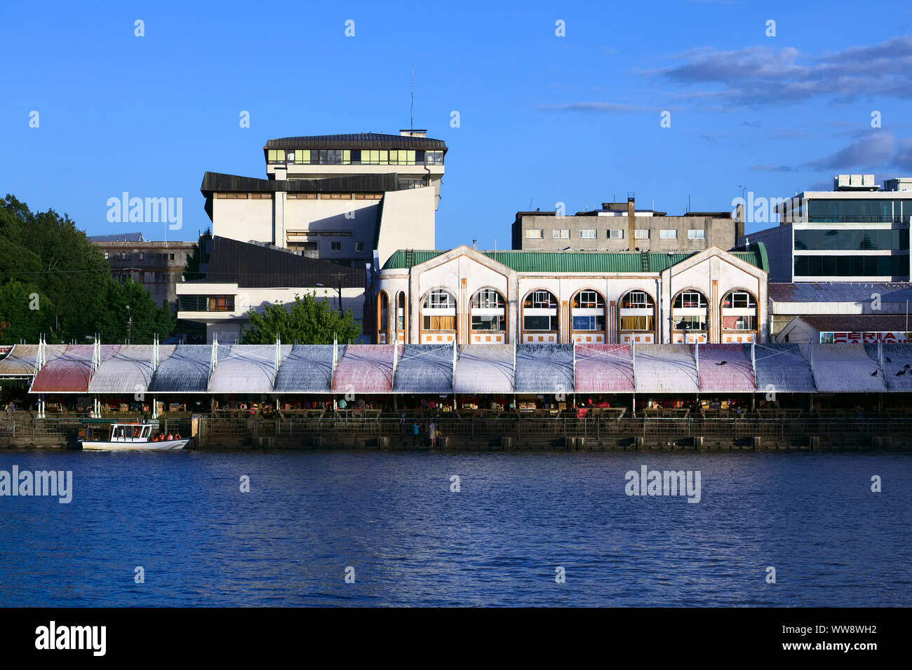 VALDIVIA, CHILE - FEBRUARY 3, 2016: Feria Fluvial (riverside market selling fish, fruit, vegetable) and behind it the Municipal Market in Valdivia Stock Photo