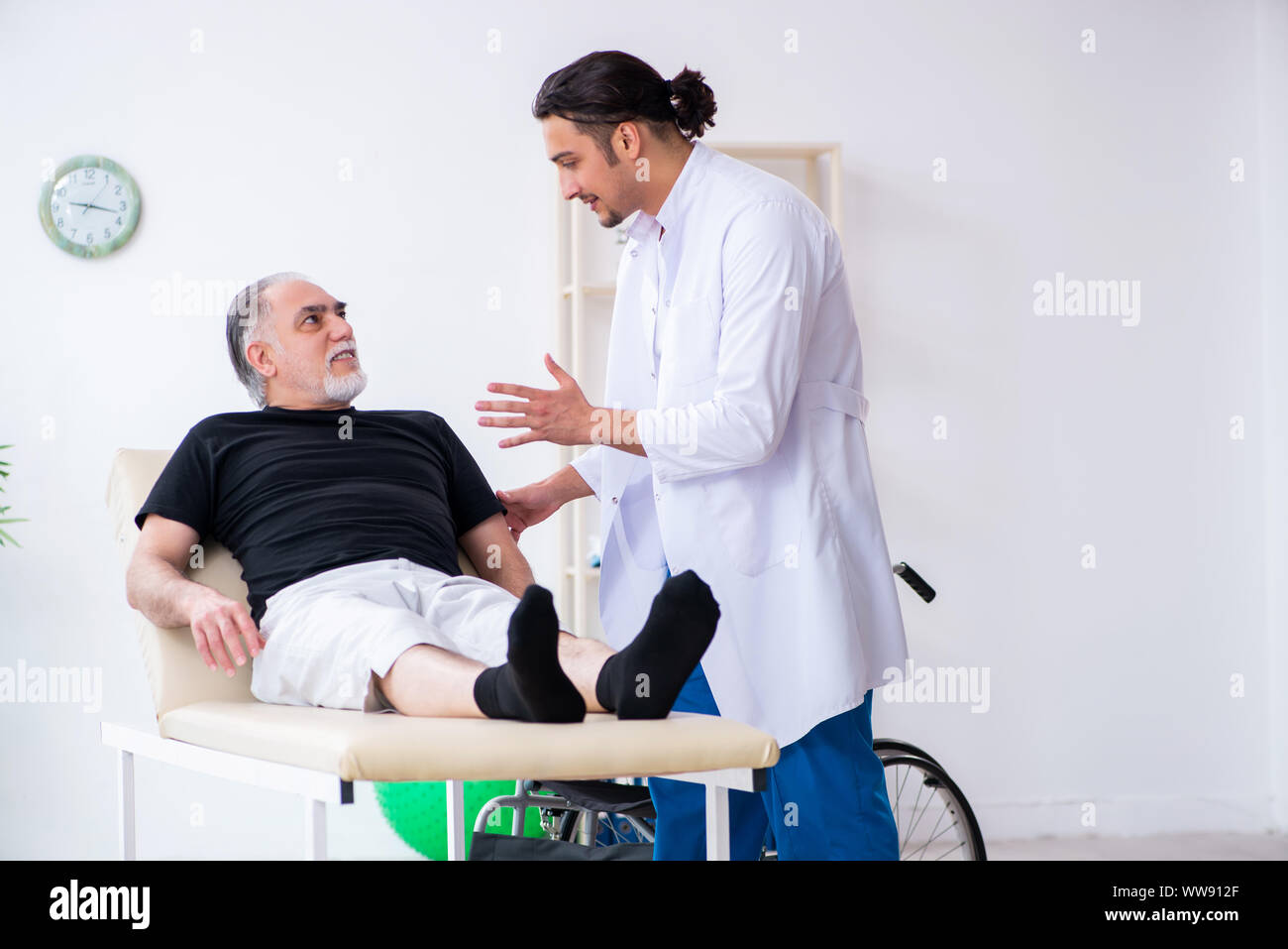 Medic examining injured man hi-res stock photography and images - Alamy