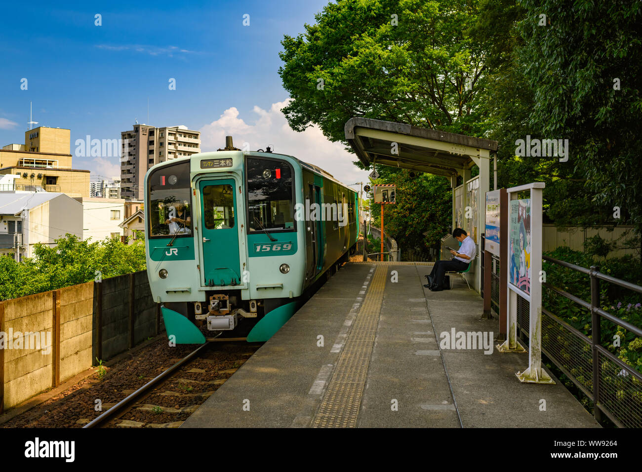Kagawa, Japan - 25 July 2019: Double carriage train reaching old train station Ritsurin-Koen-Kitaguchi Station, Kagawa, Japan. Stock Photo