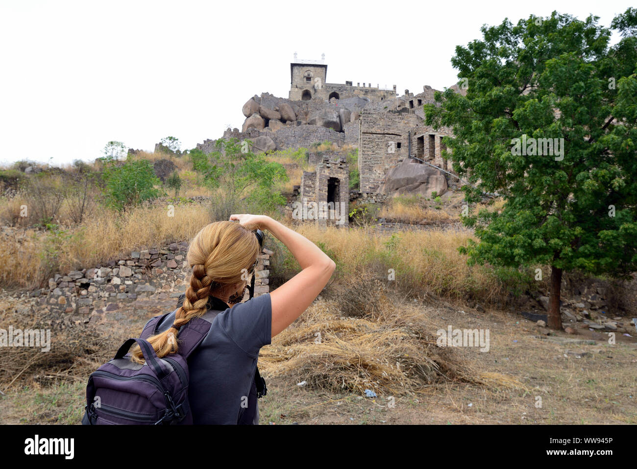 Tourist from Europe photographing Golconda Fort, also known as Golkonda or Golla Konda is a fortified citadel located in Hyderabad, India Stock Photo
