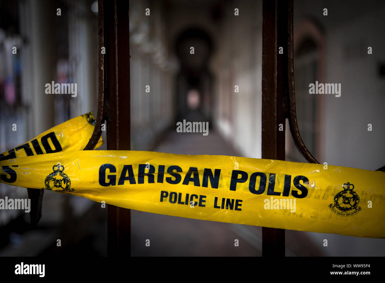 Yellow tape with wordings of police line do not cross in both English and Malay language Stock