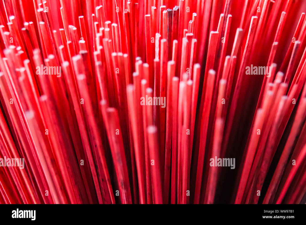 Close up of the boldly colored hand-crafted incense sticks in the famous Thuy Xuan Incense Village in Hue, Vietnam Stock Photo