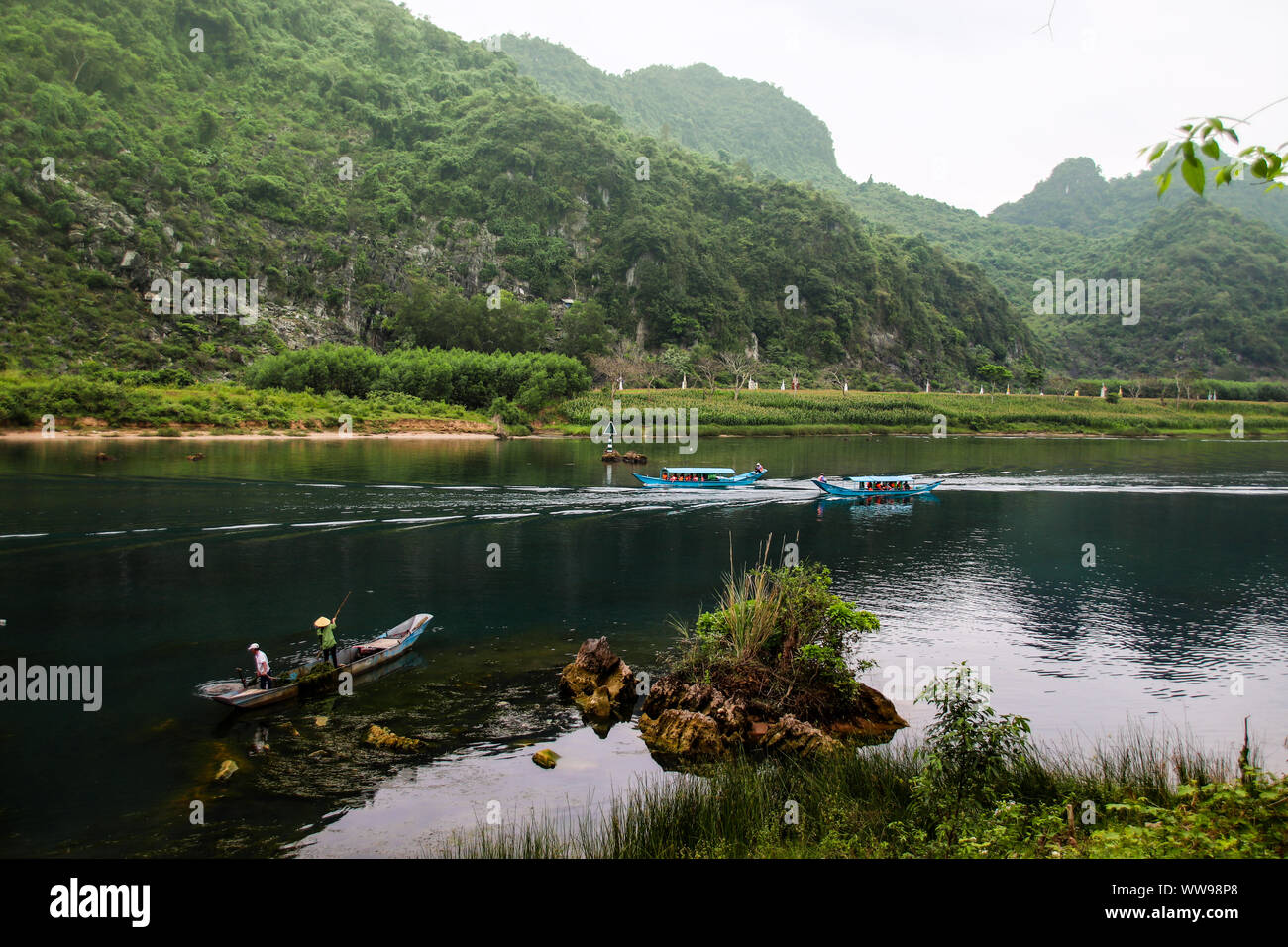 Scenic view of Son River with tour boats in Phong nha, Vietnam. A popular travel destination famous for pristine nature and wilderness Stock Photo