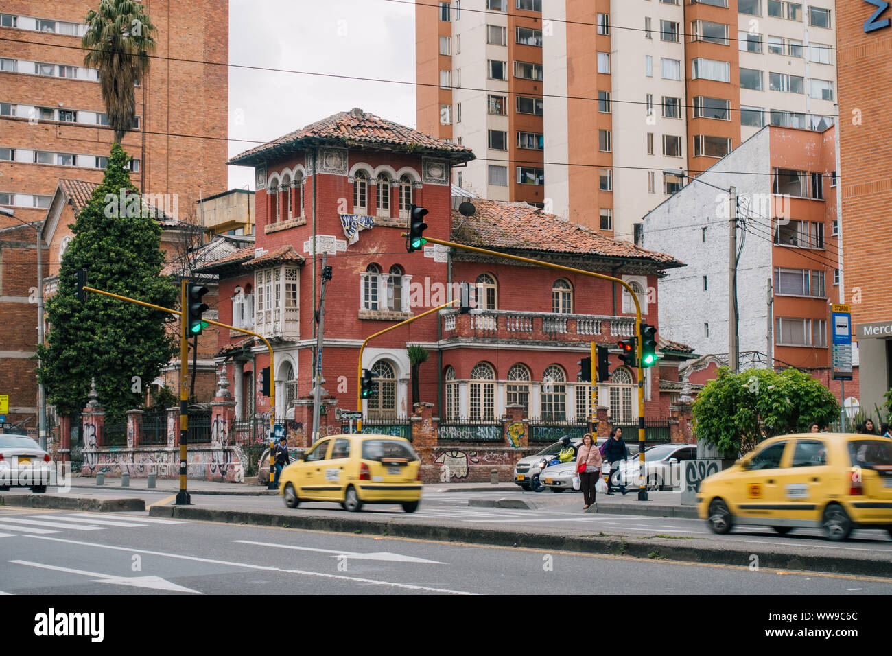 a Spanish colonial style house stands out on the corner of a busy traffic intersection in Chapinero, Bogota, Colombia Stock Photo