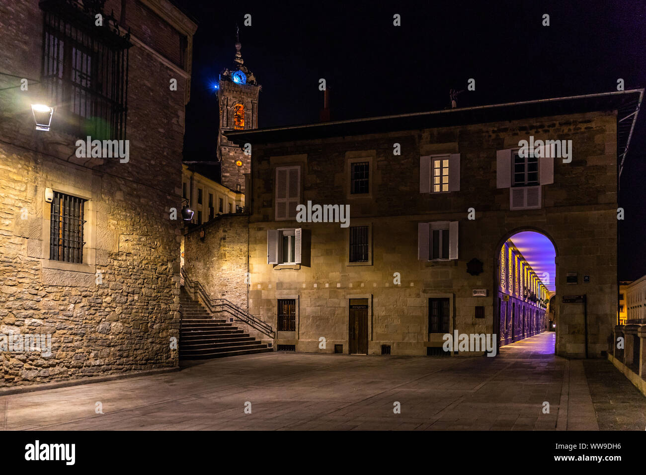 Night view of the medieval historic center of Vitoria Gasteiz with Los Arquillos building and the tower bell of Church of San Vicente Martir Stock Photo