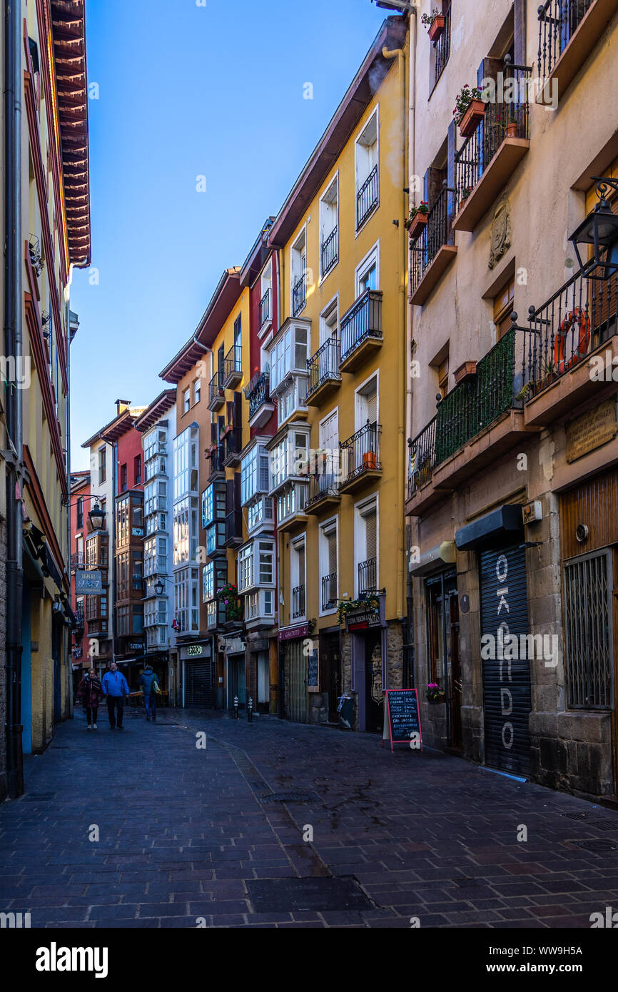 Colorful traditional houses lined along a pedestrian street in Vitoria historic center. Vitoria-Gasteiz, Basque Country, Spain, January 2019 Stock Photo