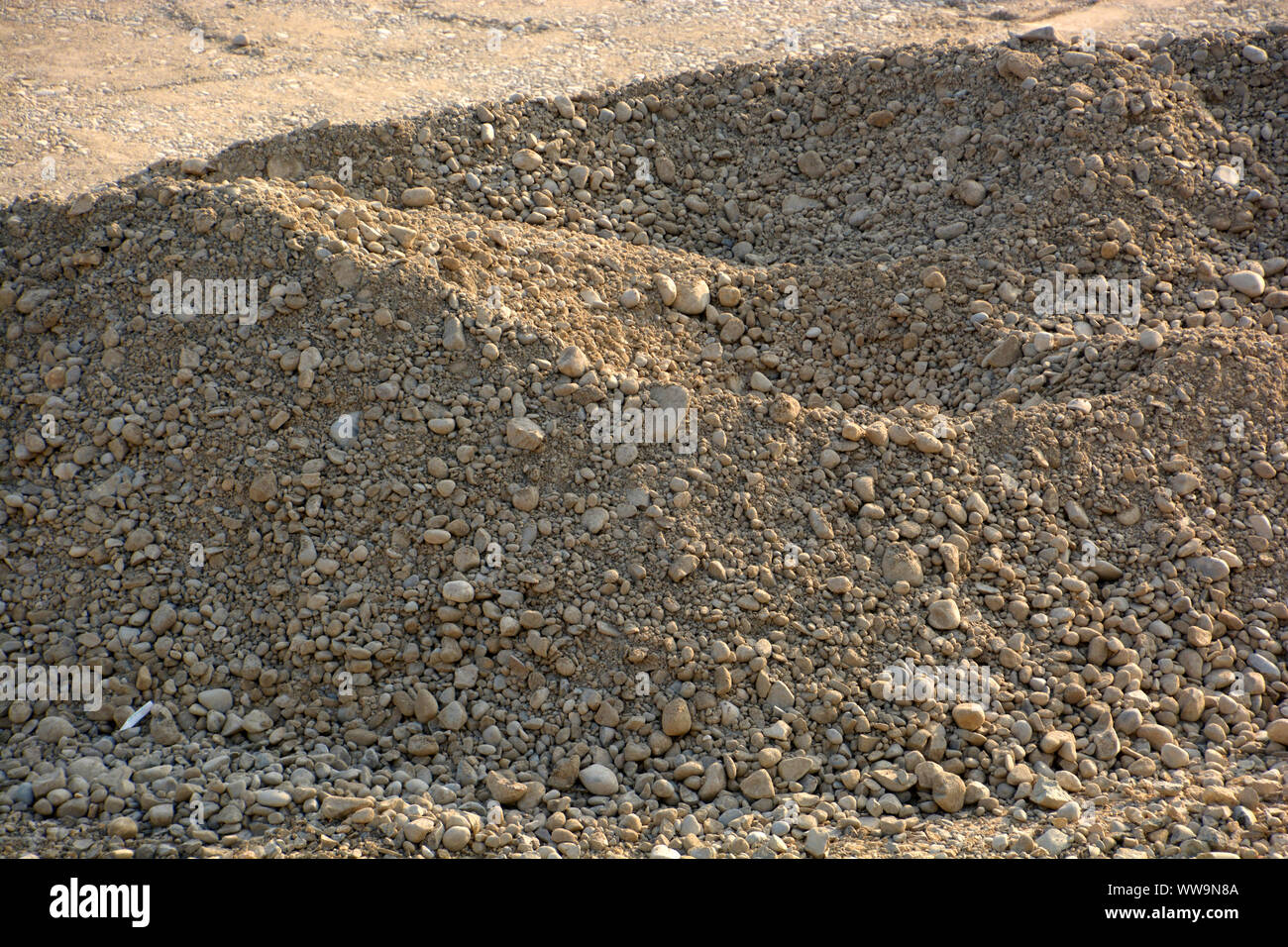 gravel pit excavation site in the evening sun, pile of gravel and ...