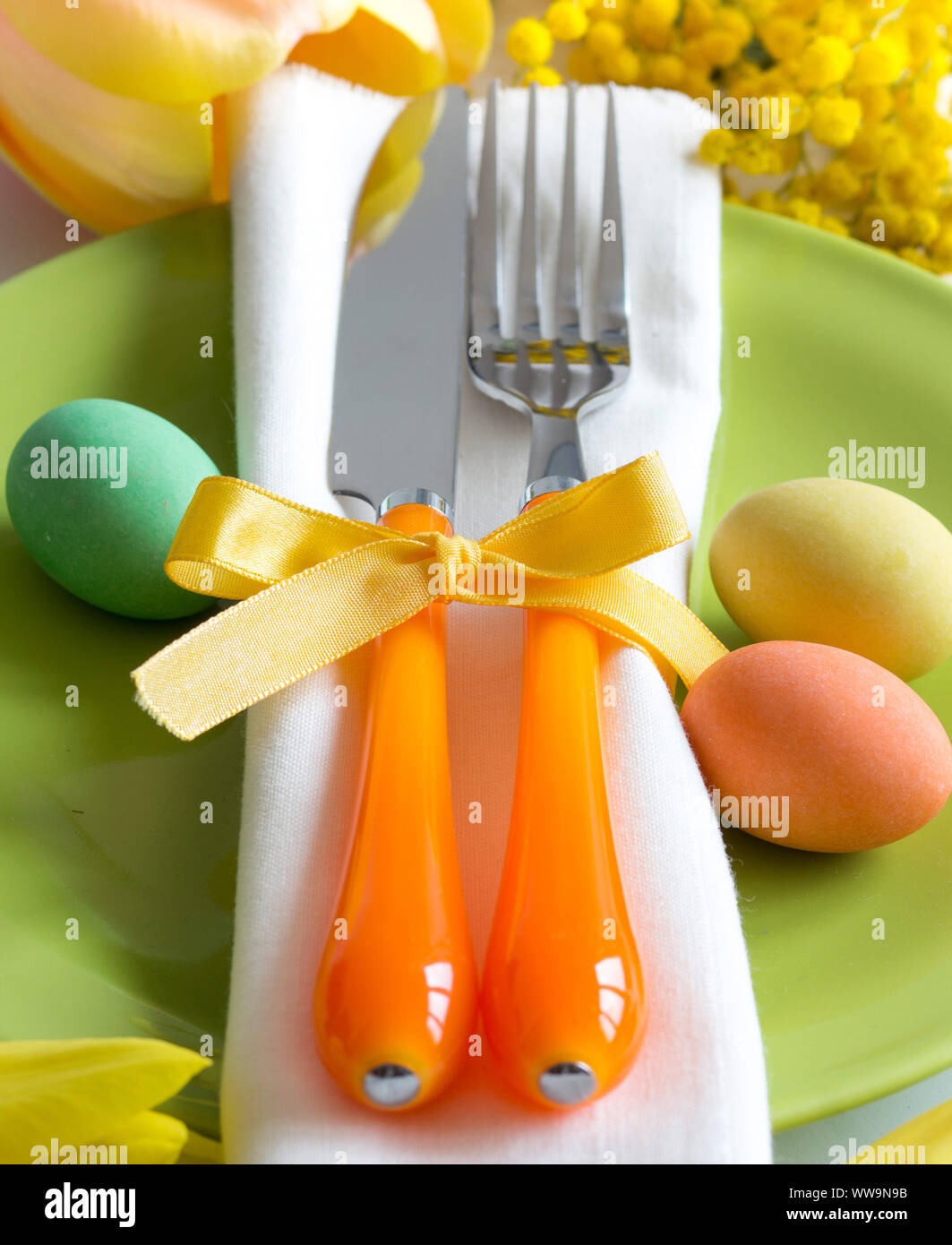 Easter table setting with yellow flowers and eggs Stock Photo Alamy