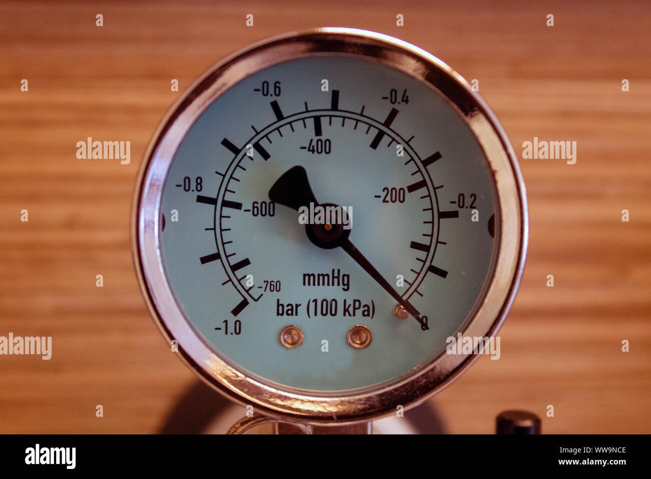 Close up front portrait of a pressure gauge indicating zero pressure. Elegant, metal, copper colored and with copy space. Stock Photo