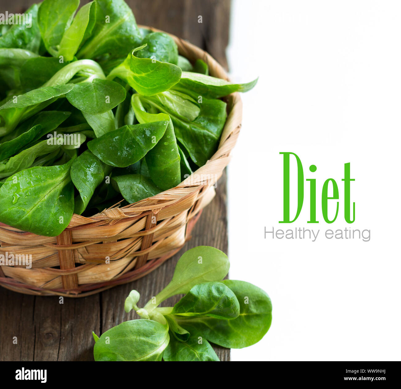 Field salad in a bowl on the old wooden table Stock Photo - Alamy