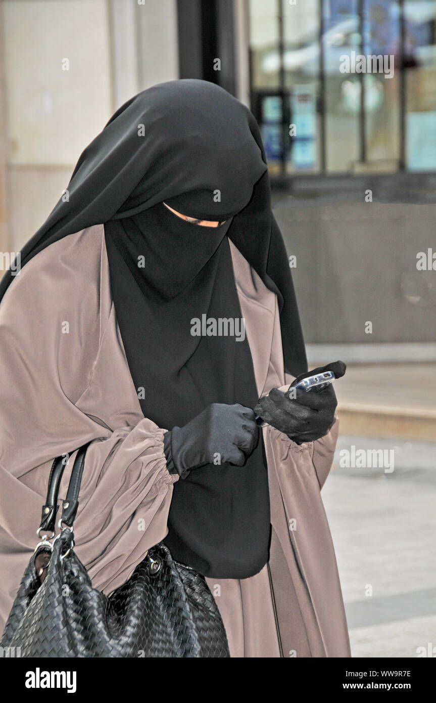 woman wearing burka in street, Paris, France Stock Photo
