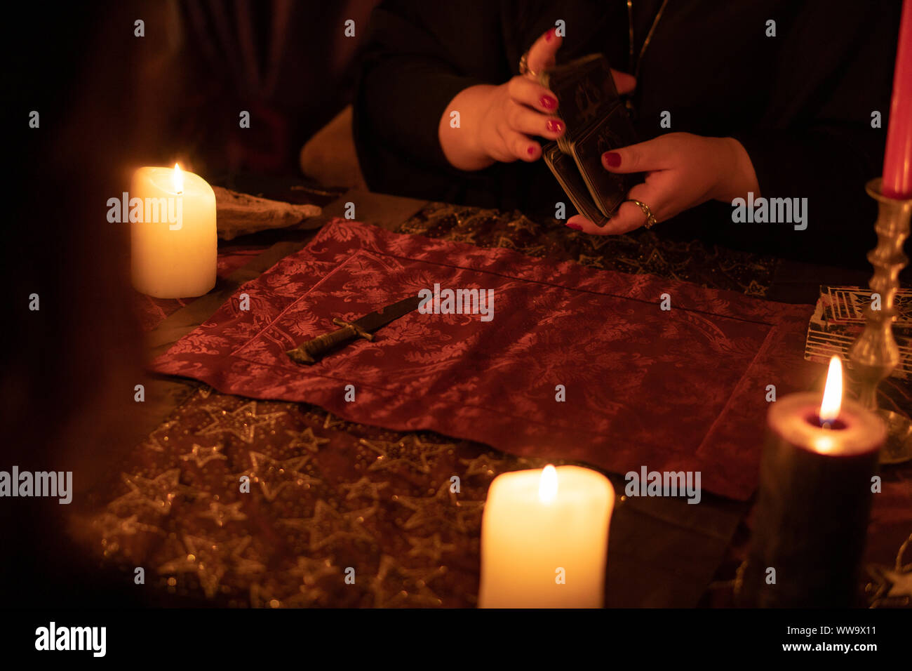Fortune Teller Woman In Dark Room With Lots Of Candles