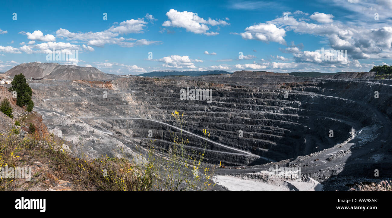 Panorama of the deep open stone pit at the noon Stock Photo