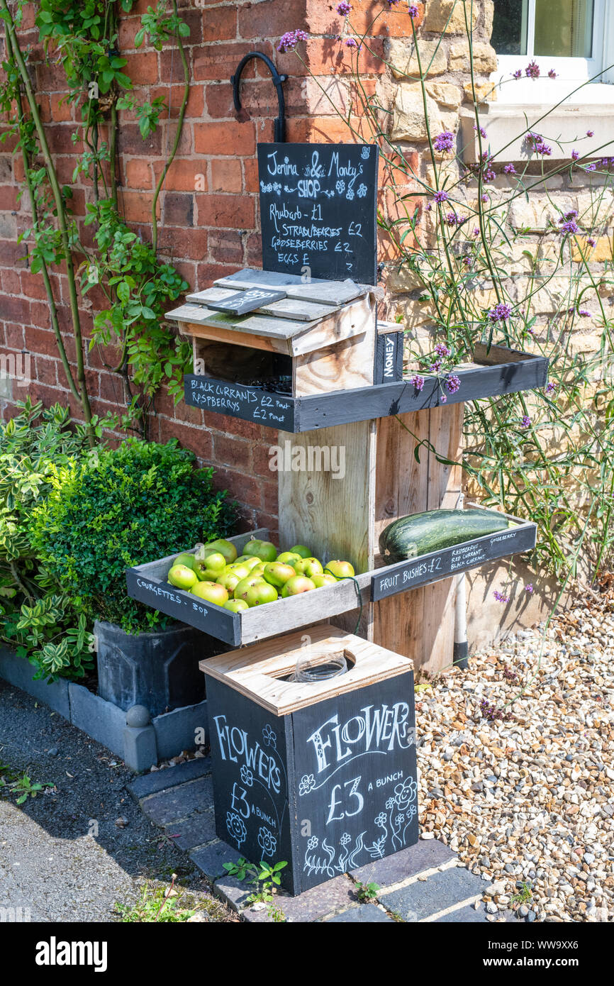 Local produce for sale outside a house. Little Comberton, Cotswolds, Wychavon district, Worcestershire, UK Stock Photo