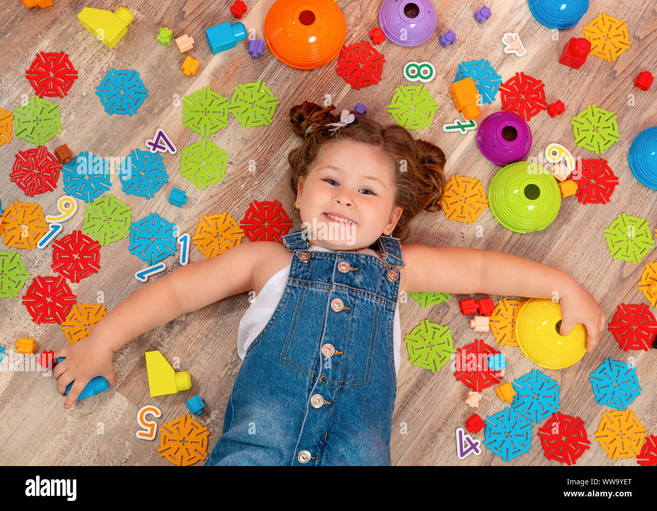 Little girl playing with block toys in kindergarten Stock Photo - Alamy