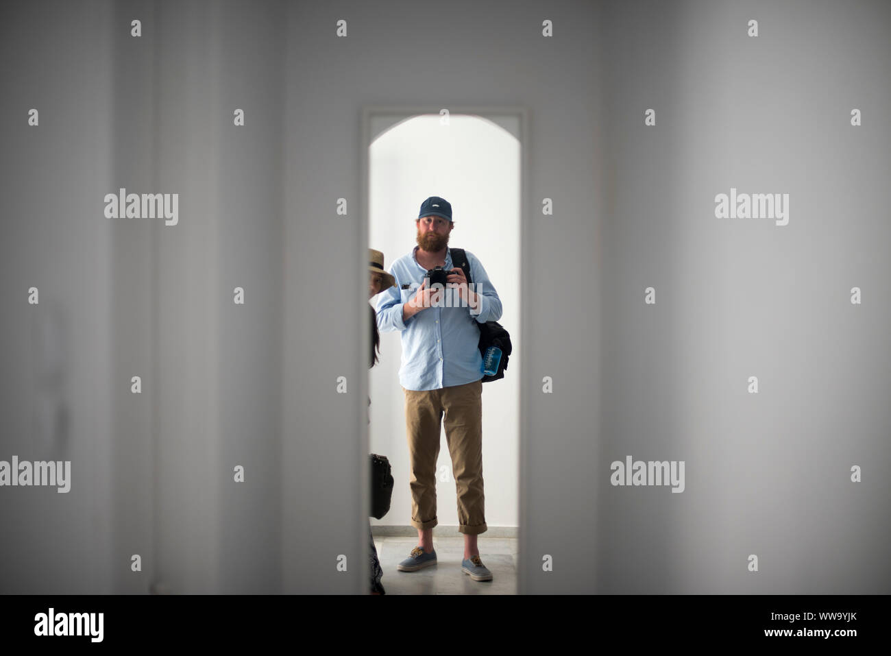 Naxo, Greece - June 26, 2018: Tourists take a photo in a mirror in the Old Town neighborhood of Naxos, a Greek island popular with tourists. Stock Photo