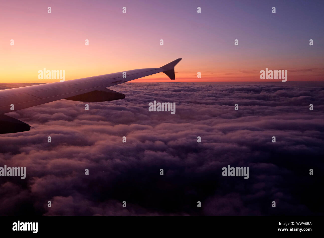 Airplane Window Seat View Flying Into The Sunset Stock Photo Alamy