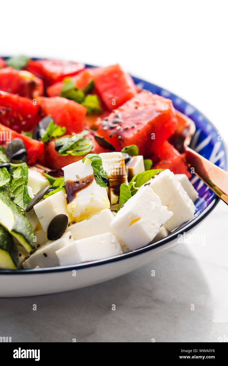 Colorful turmeric chickpea watermelon salad with feta cheese, tomatoes