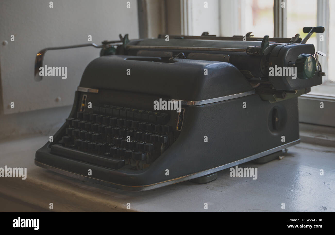 Old retro typewriter standing on the windowsill. Stock Photo