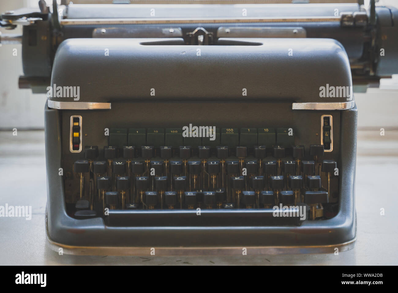 Old retro typewriter standing on the windowsill. Stock Photo