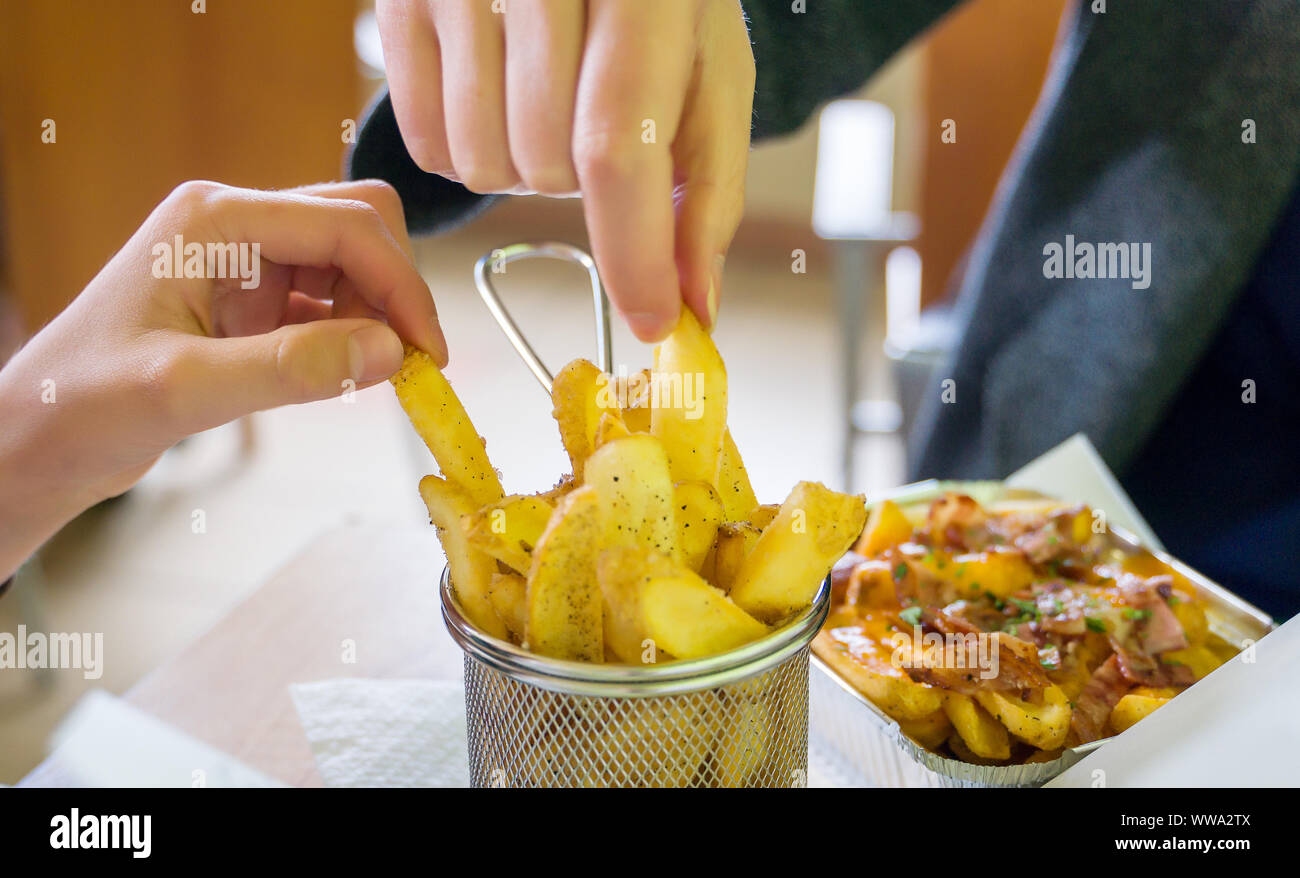Fast food. Family eating french fries in restaurant Stock Photo - Alamy