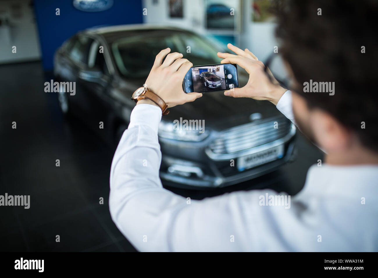 Handsome man take photo with his new car Stock Photo - Alamy