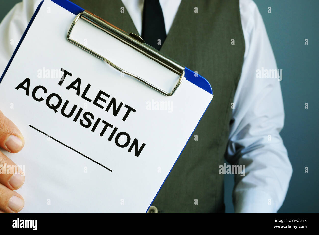 Man is holding sign talent acquisition strategy. Stock Photo