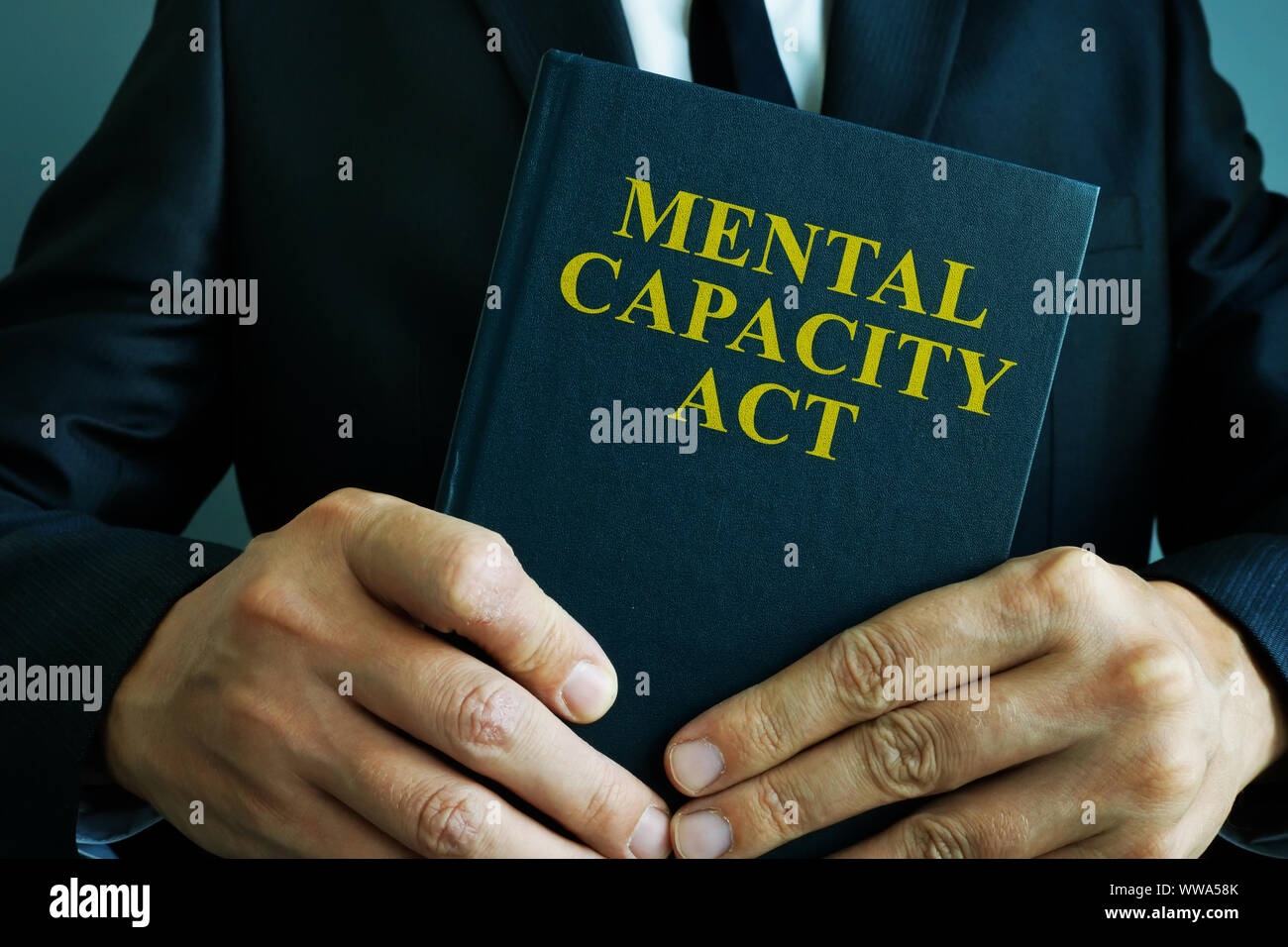 Man is holding mental capacity act. Stock Photo