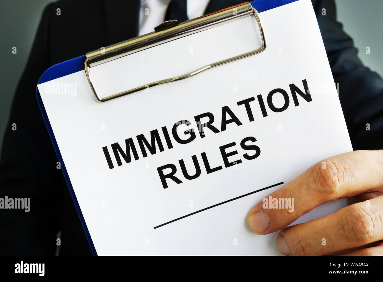 Layer is holding Immigration rules. Stock Photo