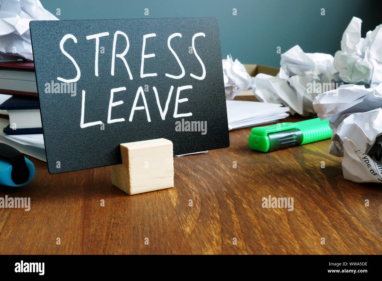 Stress leave concept. Office desk with paper balls. Stock Photo