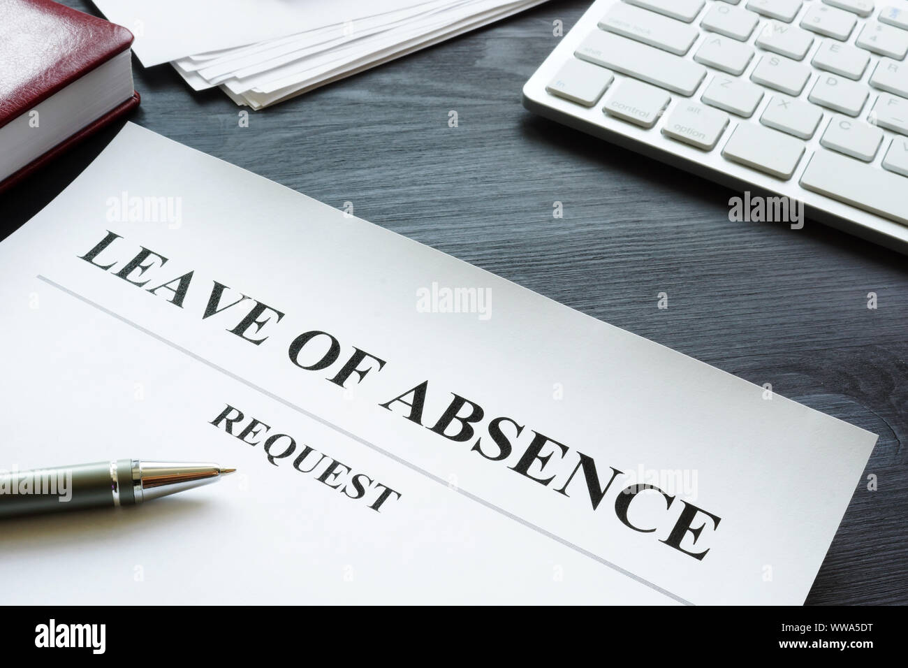 Leave of absence request on the table. Stock Photo