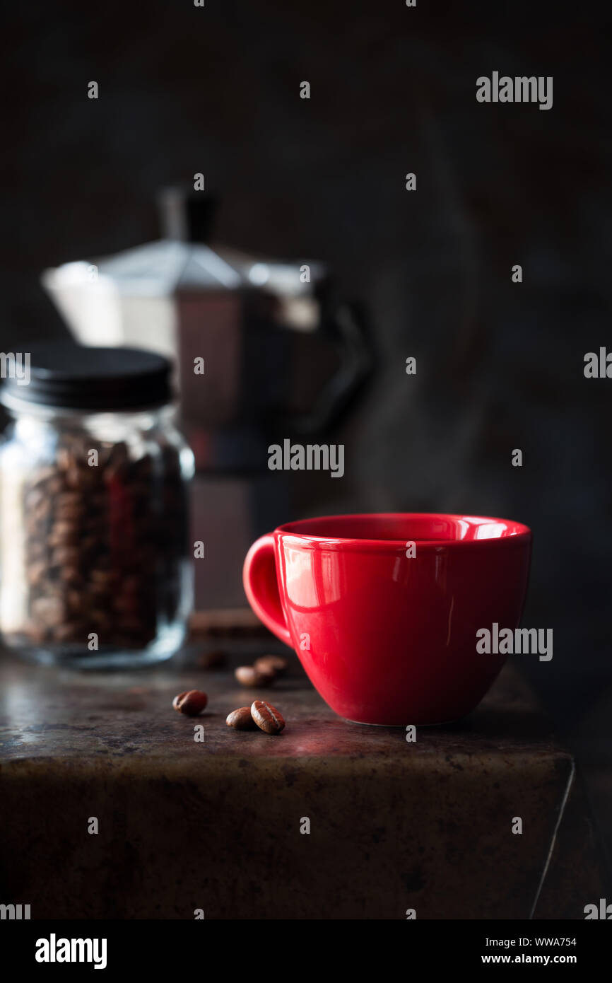Red cup of coffee against dark background. Good morning concept Stock Photo