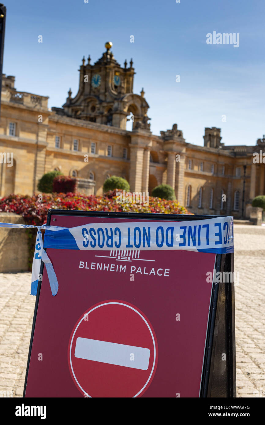 Place tape hung over Blenheim palace signs warning visitors not to cross after the theft of Maurizio Cattelan's 18 carot Golden toilet art exhibition Stock Photo